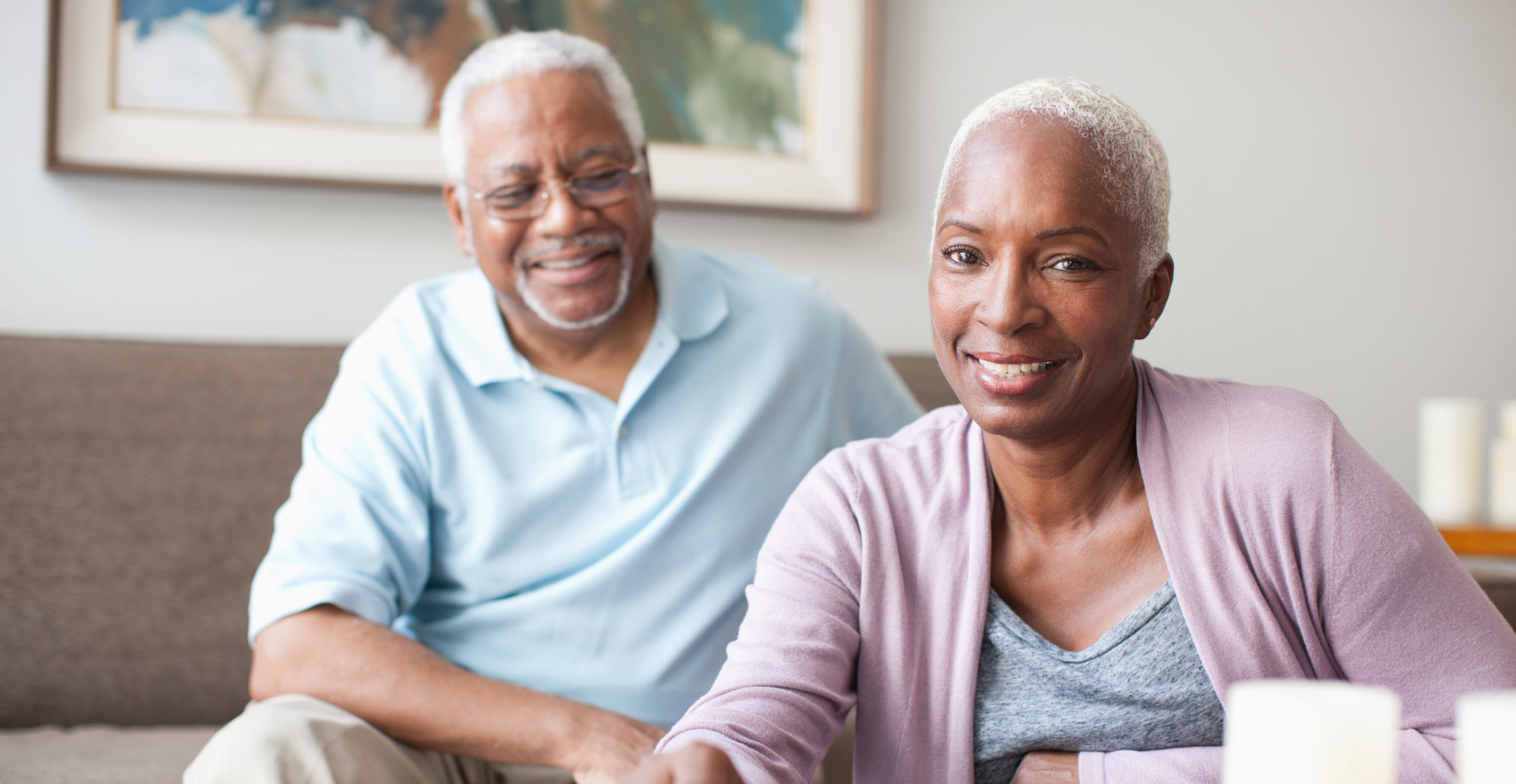 Laughing older couple playing dominoes
