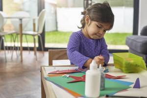 little girl playing and drawing