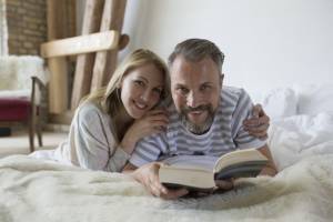 couple in bed with book
