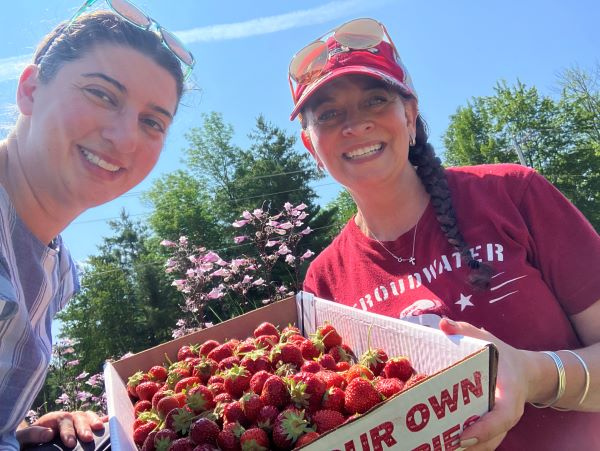 Patient Alison with physical therapist Angela DePaola picking strawberries