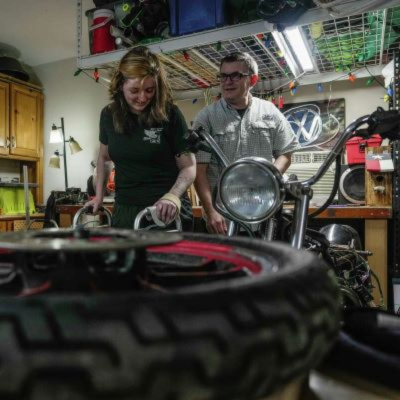 Patient Meissa Neumann and her dad Ernie work on building a motorcycle together in their garage