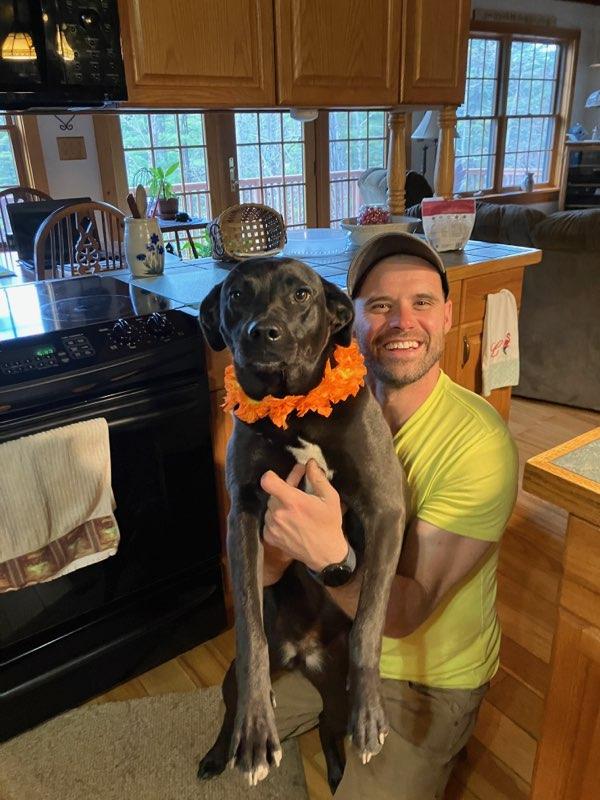 Patient Pete with his dog in their kitchen.