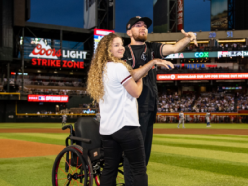 Patient Tyler Moldovan with his wife at the Arizona Diamondbacks stadium throwing first pitch.