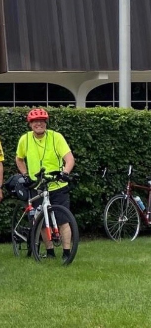 Patient Clark wearing a helmet with his bike.