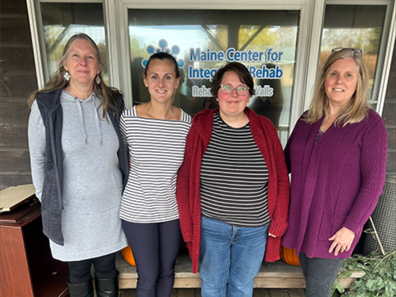 Patient Robbie standing with her therapy team in front of RWW