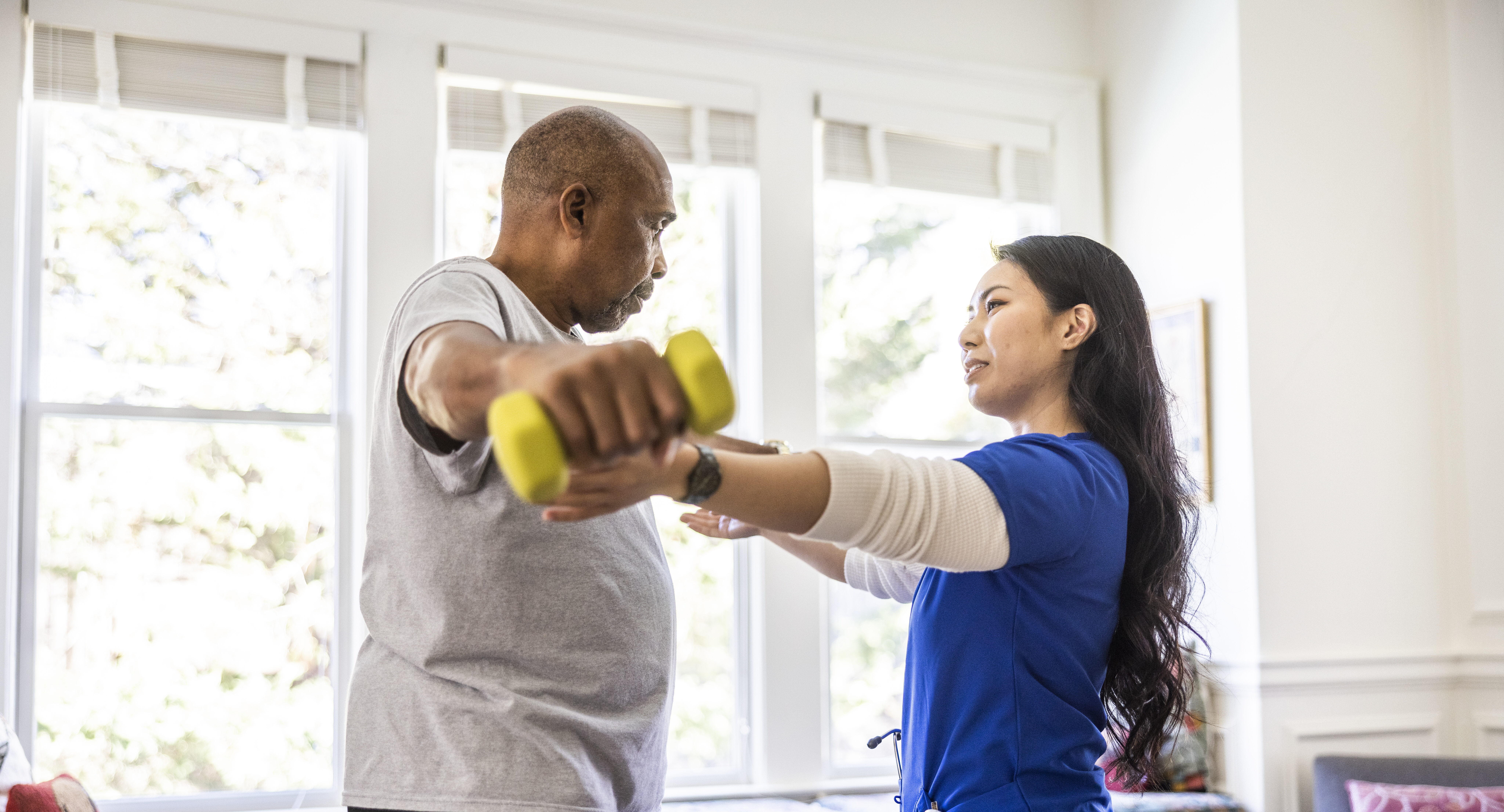 Physical therapist working with patient on strength training