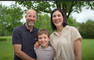 Patient Matt is smiling in a picture with his young son and wife.
