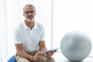 Physiotherapist using digital tablet