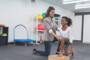 girl working with physical therapist