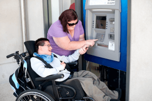 therapist helping man at atm