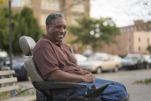 smiling man in a wheelchair